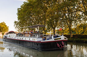 People enjoying the sun deck on the canal